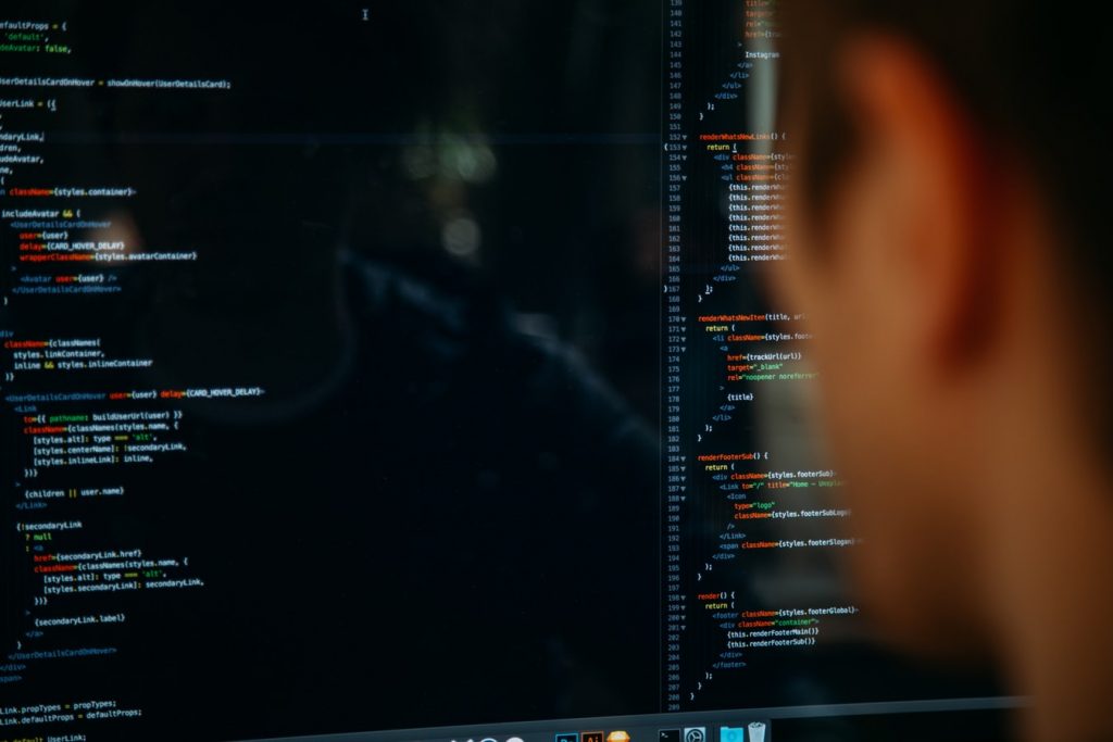 Software Engineer Looking At Coding On Computer Monitor