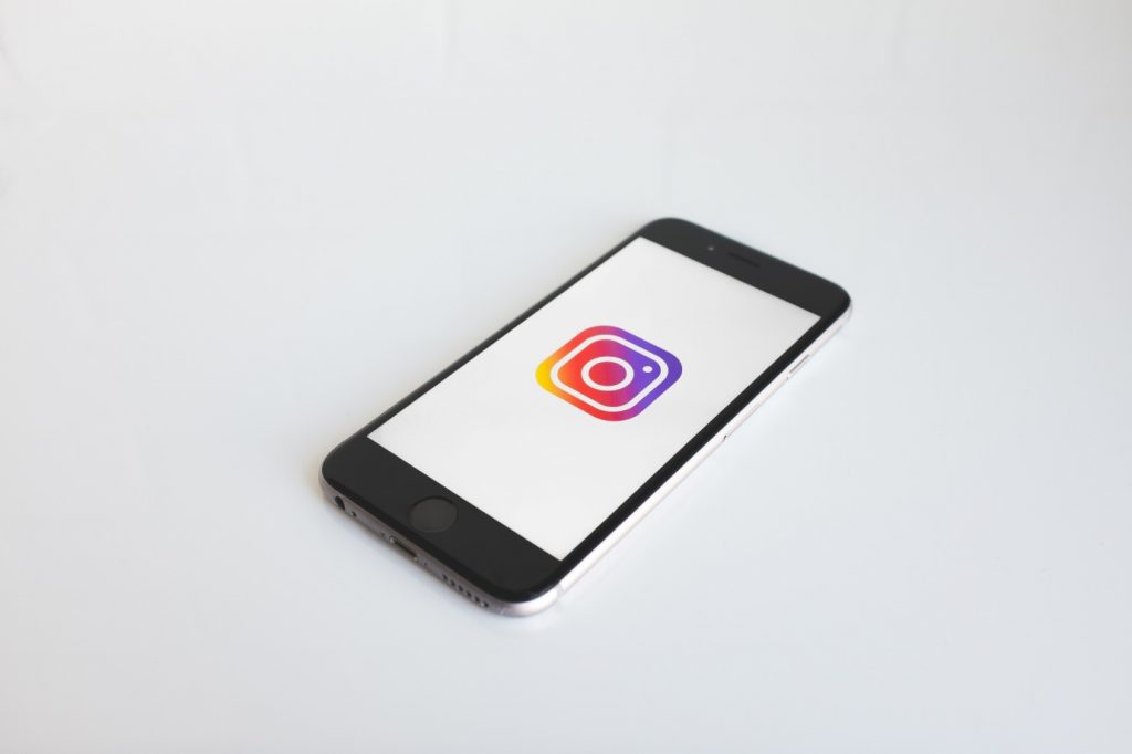 A mobile phone displaying the Instagram app logo
